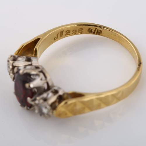 349 - An 18ct gold three stone garnet and diamond ring, set with oval and mixed-cut garnet and modern roun... 