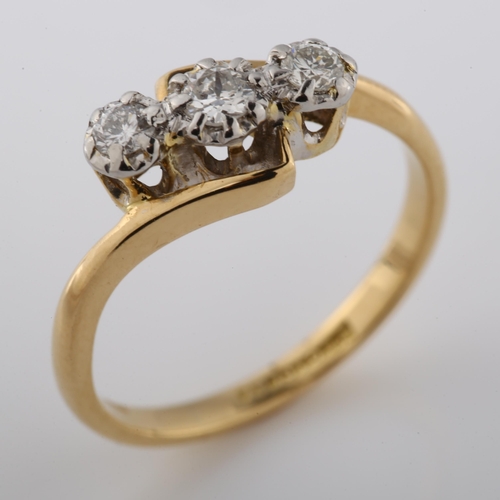 351 - An 18ct gold three stone diamond crossover ring, illusion set  with modern round brilliant-cut diamo... 