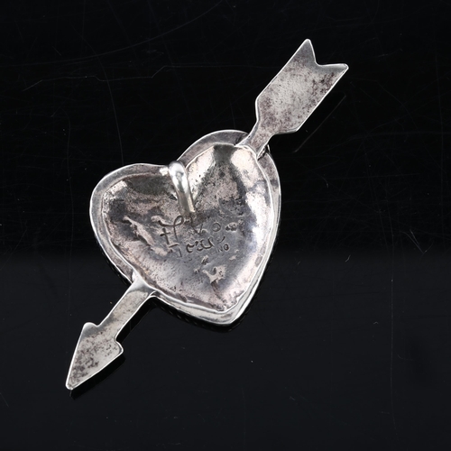 355 - FOREE HUNSICKER (1932 - 2015) - an American sterling silver heart and arrow pendant, signed, arrow l... 