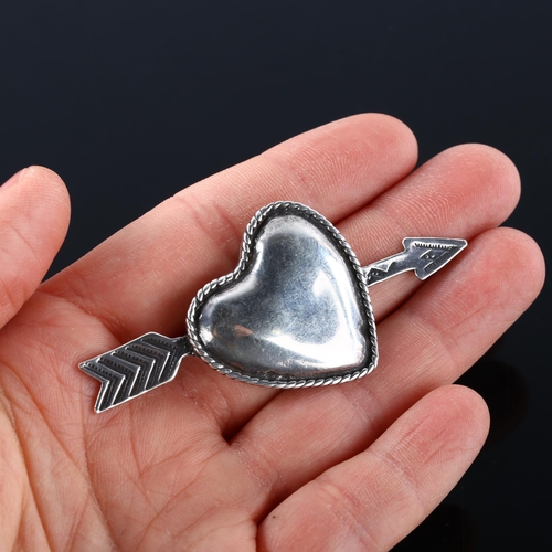 355 - FOREE HUNSICKER (1932 - 2015) - an American sterling silver heart and arrow pendant, signed, arrow l... 