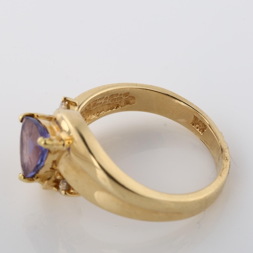 364 - A 14ct gold tanzanite and diamond crossover ring, set with trillion-cut tanzanite, setting height 11... 