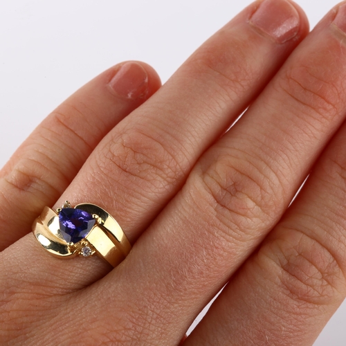 364 - A 14ct gold tanzanite and diamond crossover ring, set with trillion-cut tanzanite, setting height 11... 