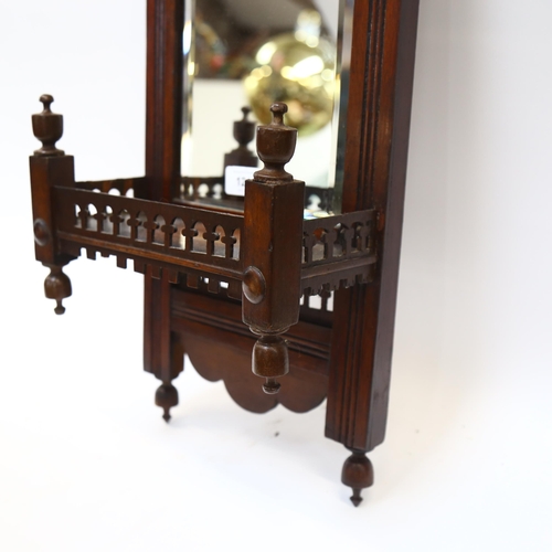 121 - An Edwardian mahogany wall shelf, with a bevelled-edge mirror back and pierced fretwork gallery, len... 