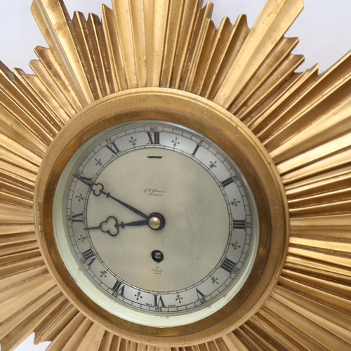 124 - A 1930s gilt starburst wall clock, by J W Benson, width 45cm