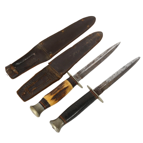 143 - 2 Second World War period daggers in sheaths, both with makers marks William Rodgers, Sheffield, lon... 