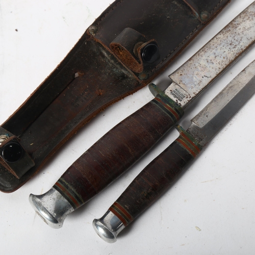 157 - A graduated pair of Vintage drop point knives, in original fitted leather scabbard