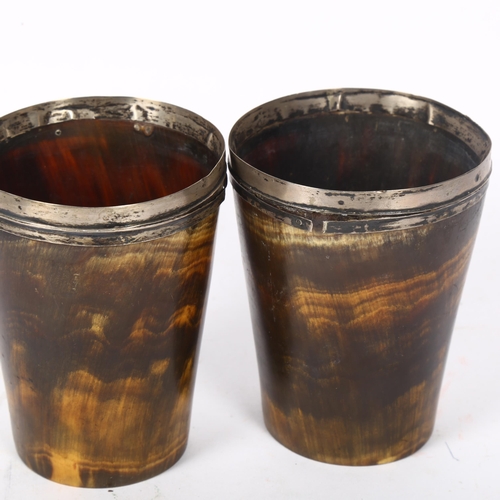 162 - A pair of early 19th century horn beakers, with unmarked silver mounts