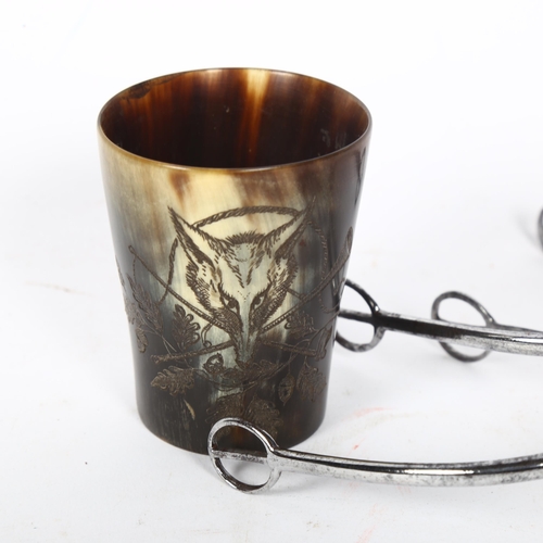 182 - A small horn beaker with engraved fox hunting scene, and a pair of Antique steel spurs