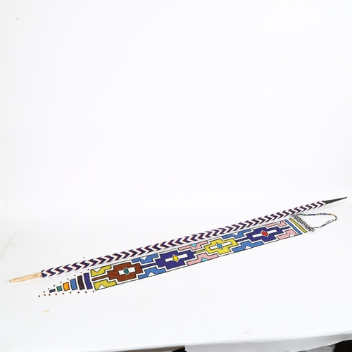 197 - An African beadwork hanging panel and covered spear, spear length 120cm