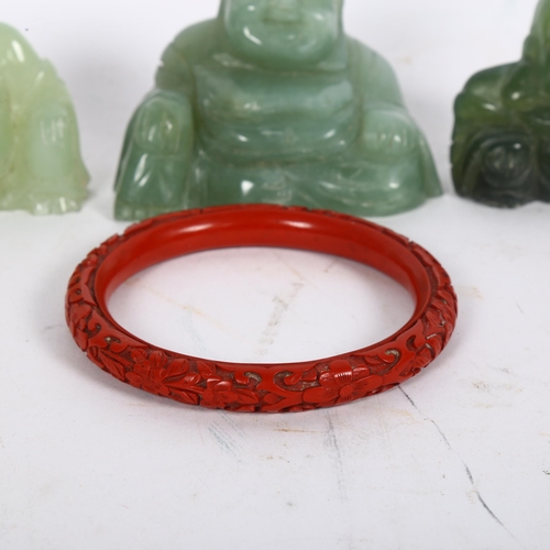 202 - 3 nephrite/green stone Buddhas, tallest 6cm, and a cinnabar bangle