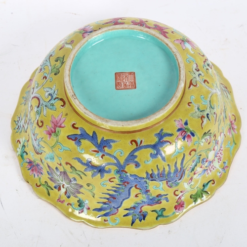 204 - A Chinese famille rose bowl, with flared lobed rim, on turned foot, with mystical beast design, diam... 