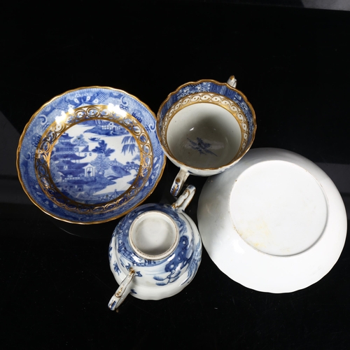 206 - A pair of Chinese design blue and white cups and saucers, with gilded design