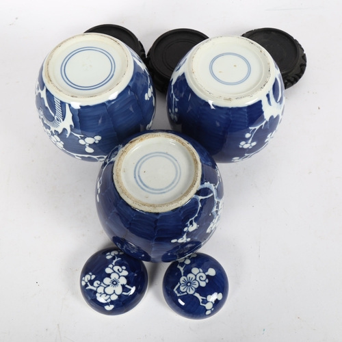 209 - 3 Chinese blue and white ginger jar and covers, all prunus decorated, on stands, 1 lacking its lid, ... 