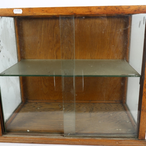 247 - An early 20th century oak-framed table-top shop display cabinet, with single glazed shelf, width 51c... 