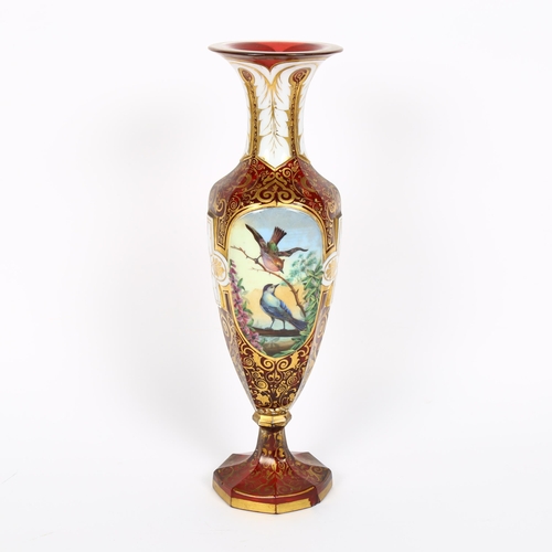 31 - A 19th century Bohemian cranberry glass portrait vase, allover gilded and white enamelled decoration... 