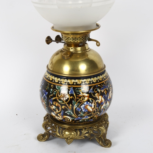 46 - An Antique Maiolica and brass-mounted oil lamp, the font decorated with Bacchanalian scenes, complet... 