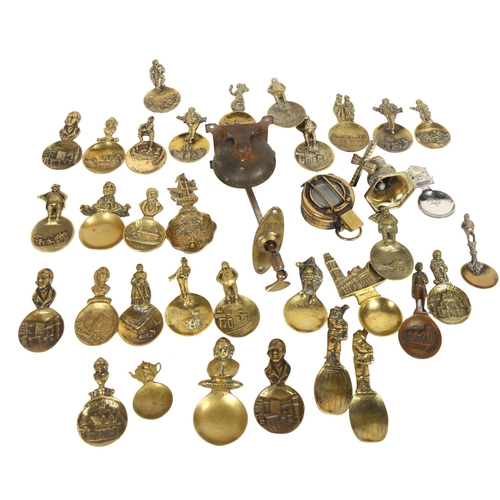 255 - A quantity of brass tea caddies or collector's spoons, including an Antique doorbell