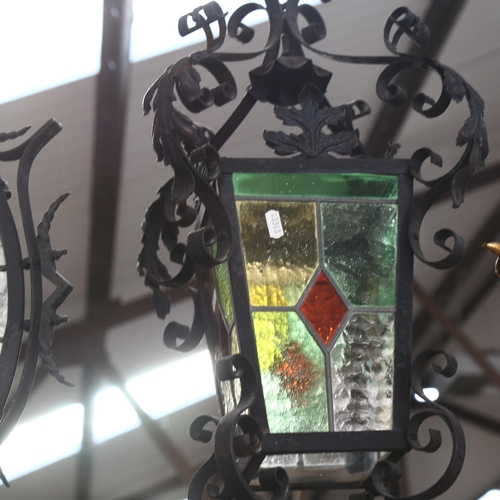 271 - A pair of scrolled wrought-iron lanterns, with leadlight glazed panels, the pair do not match, large... 