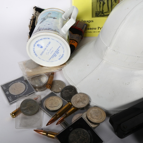 301 - A box containing various militaria items, including various military ephemera, badges, compass, coin... 