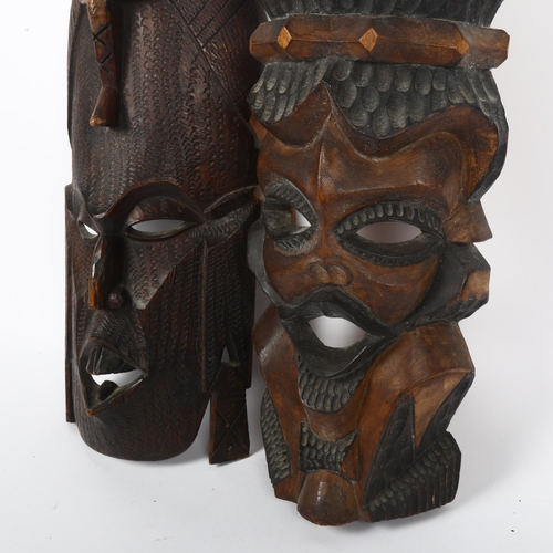 316 - 2 modern African carved masks, largest 48cm