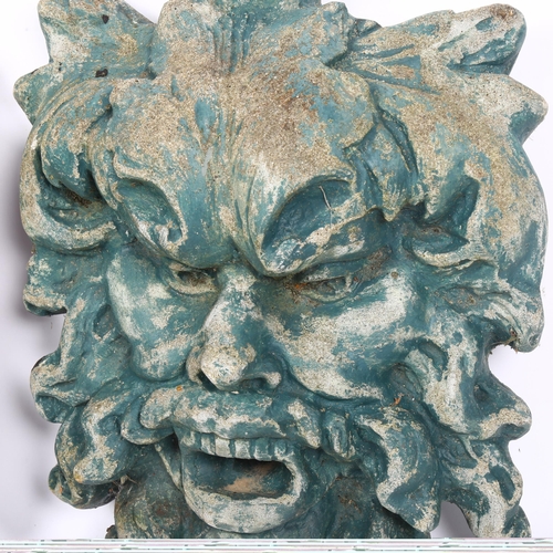 321 - A pair of Pagan King Green Man wall plaques stone garden ornaments, height 34cm, width 26cm