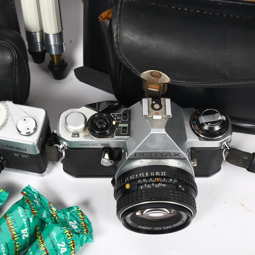 334 - A Pentax Me Super 50mm camera and lens with an additional 135mm lens, tripod and original carry case... 