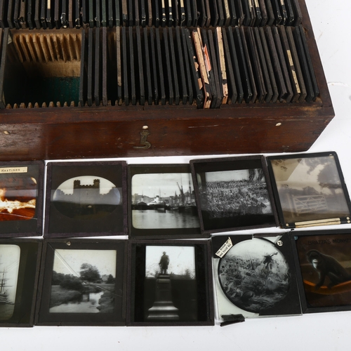 343 - A collection of various interesting magic lantern slides in a case, including some coloured jester s... 