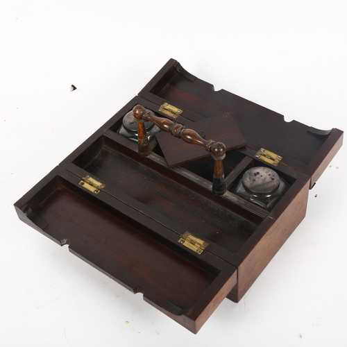 357 - A Victorian rosewood travelling desk stand, with mother-of pearl design to top, inkwells are present... 