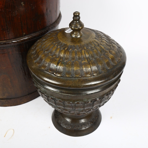 415 - A Chinese steel-bound elm well bucket, height 63cm, and a patinated brass urn and cover, on turned f... 