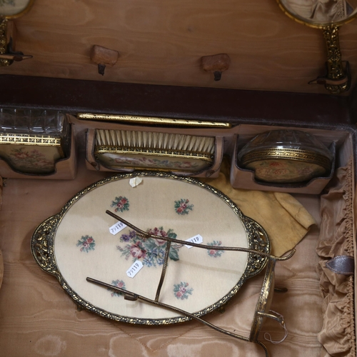 444 - An early 20th century lady's leather vanity case, with fitted interior complete with dressing table ... 