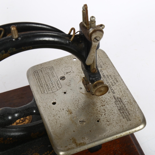 455 - Antique Willcox & Gibbs sewing machine with gilded decoration, on plinth, with original tin for acce... 