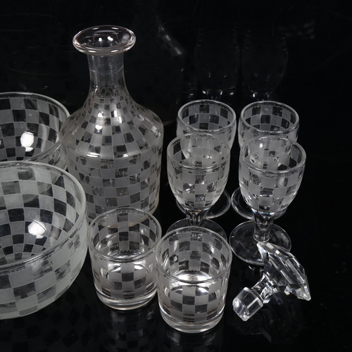 464 - A glass decanter with matching bowls and glasses, with etched chequer board pattern