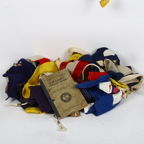 476 - A collection of Naval pennants, and a seaman's pocket book 1943