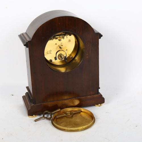 511 - An inlaid mantel clock with brass columns and 8-day movement, height 23cm