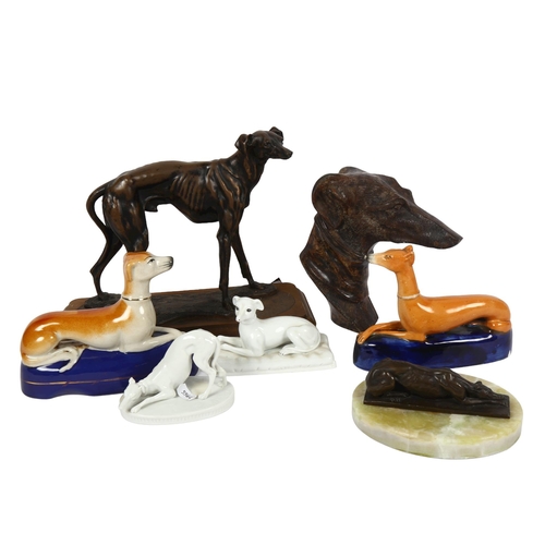 517 - A bronze resting Greyhound on onyx plinth, 14cm overall, a Staffordshire Greyhound desk stand, and o... 