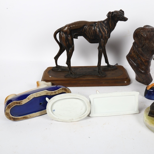 517 - A bronze resting Greyhound on onyx plinth, 14cm overall, a Staffordshire Greyhound desk stand, and o... 