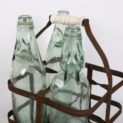 551 - 2 stoneware storage jars, tallest 27cm, a metal bottle carrier with 3 bottles