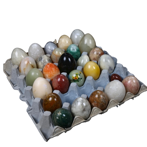 557 - A collection of onyx, and other decorative eggs