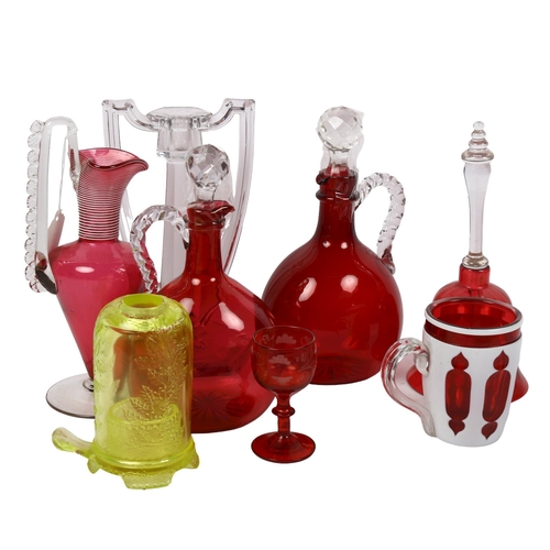 559 - 2 cranberry glass jug decanters, tallest 24cm, a uranium glass candle stand and cover, hexagonal can... 