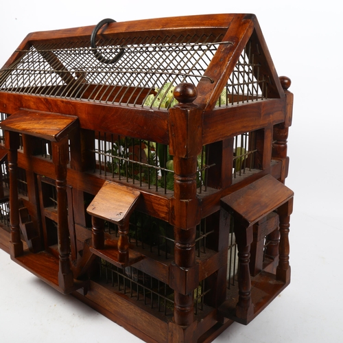 580 - Ornate Oriental turned wood and wirework bird cage, length 51cm