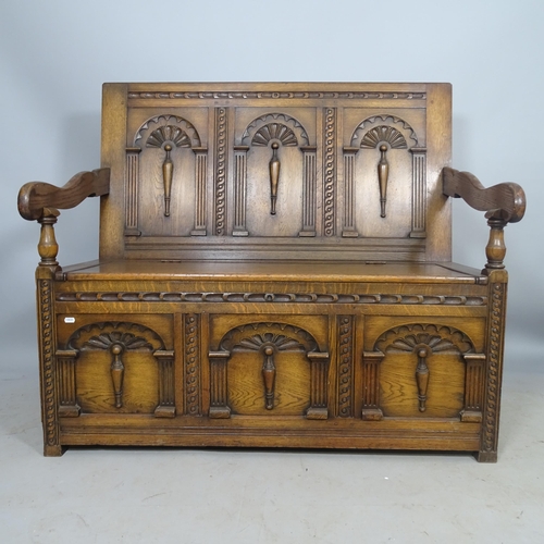 2695 - An Antique oak hall settle/monk's bench, with allover carved decoration and lifting seat, 117 x 107 ... 