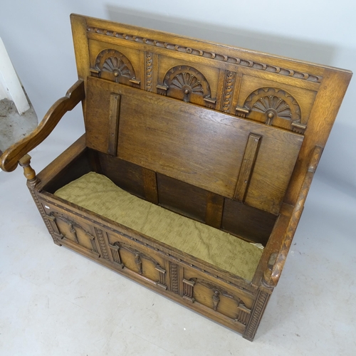 2695 - An Antique oak hall settle/monk's bench, with allover carved decoration and lifting seat, 117 x 107 ... 