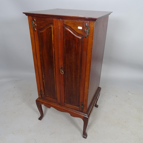 2698 - An Arts and Crafts style mahogany music cabinet, with shelf-fitted interior on cabriole legs, 52 x 1... 