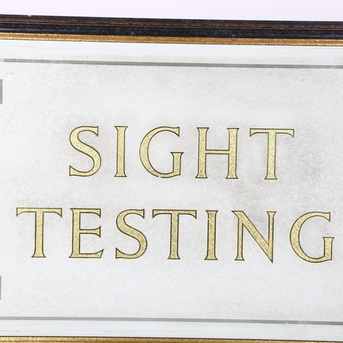 25 - A gilded glass Optician's Testing sign, framed, overall 53cm x 80cm