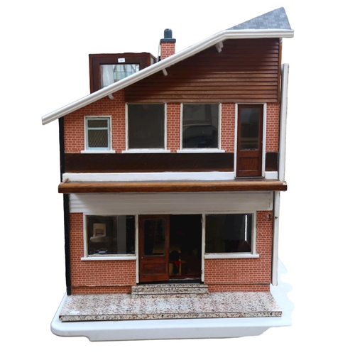 656 - A modern doll's house with 2 furnished floors, H 82cm, L63cm, W62cm