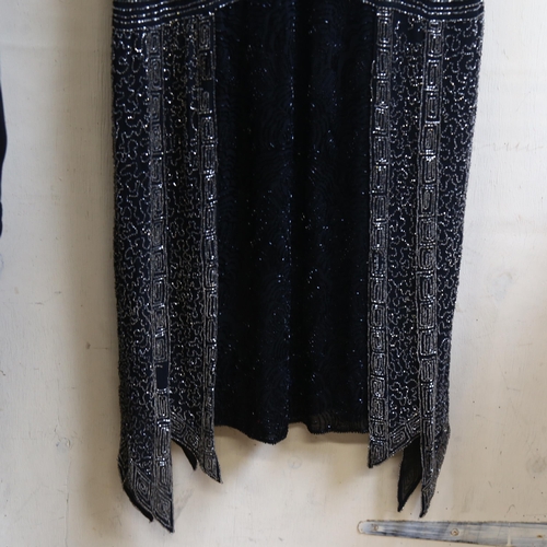 663 - A 1920s style black flapper dress, with intricate beading decoration, no size label