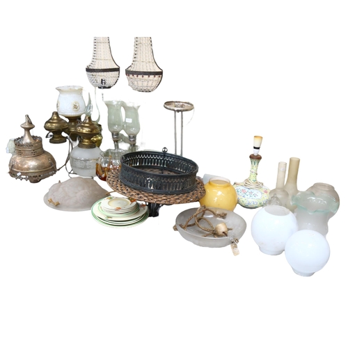 717 - A large quantity of light fittings and lamps, including various oil lamps, a cloisonne ceramic lamp,... 