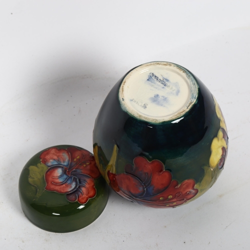 733 - A Moorcroft jar and cover with tube-lined floral decoration, height 10cm