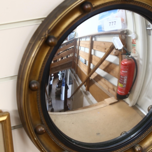 777 - A Vintage convex circular gilt-framed mirror, with ball decoration, 39cm