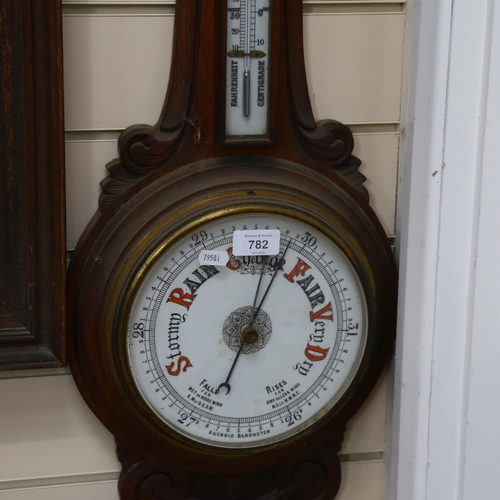 782 - Aneroid barometer with thermometer, in carved oak surround, height 89cm